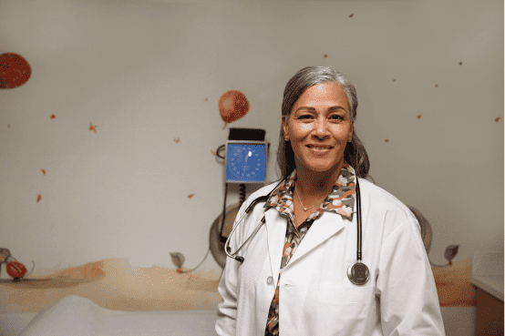 A doctor smiling in a hospital